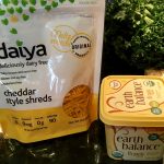An image of a container of Earth Balance fake-butter and a bag of Daiya dairy free chedar cheese.