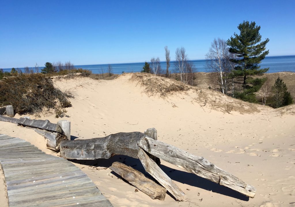 View of boardwalk trail, sandy dune, and Lake Michigan.