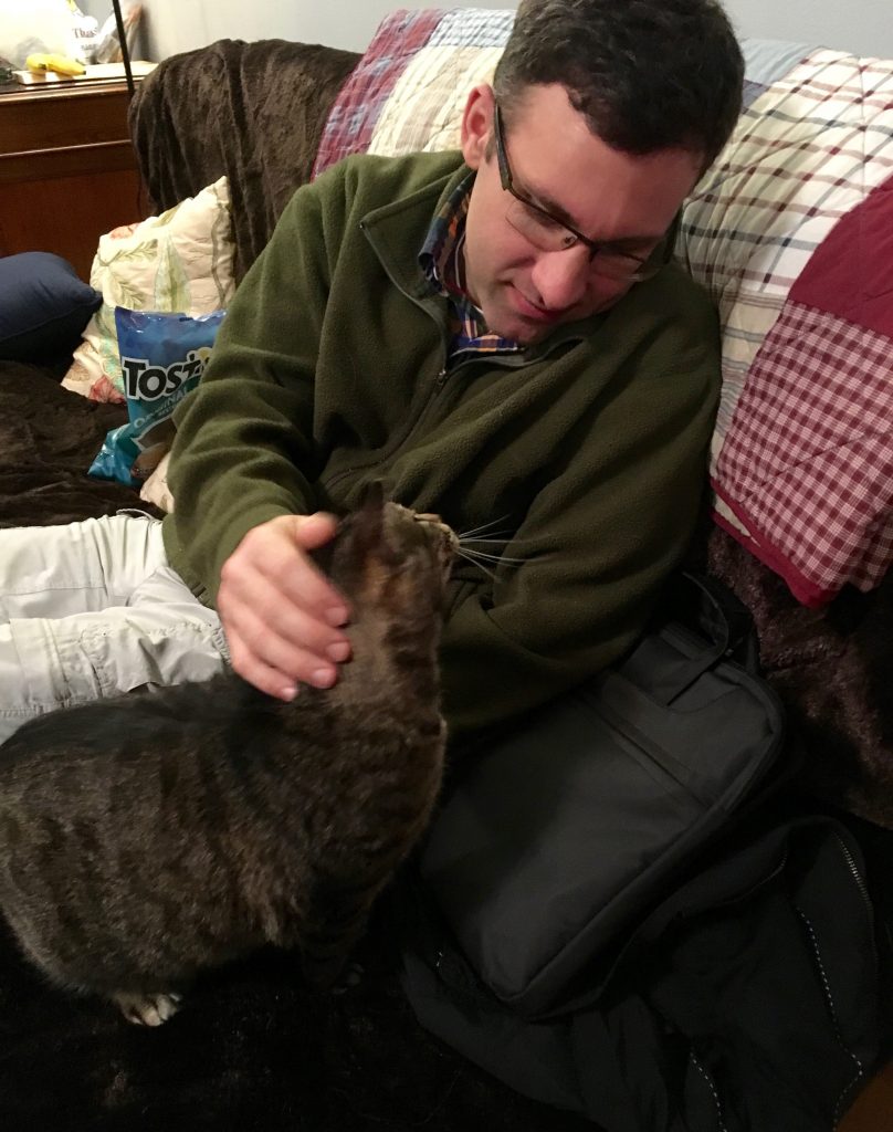 My partner and a friendly cat interacting at the end of a long day of hiking.