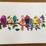An image of cartoonish birds in a color book sitting on a branch, all of which has been colored in.