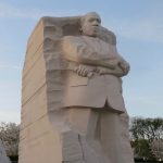 A white, stone statue of Dr. Martin Luther King, Jr.
