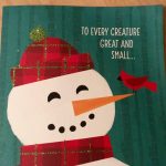 An image of a card reading "To every creature great and small..." with a snowman wearing a red scarf and hat with a red bird on his carrot nose.