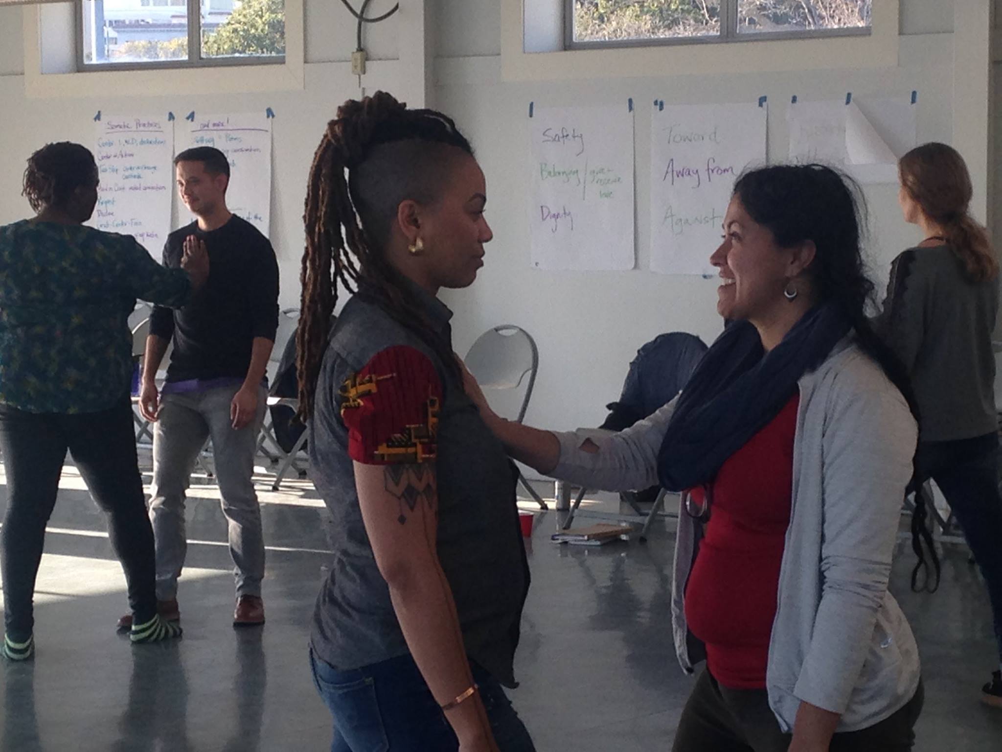 Photo of five generative somatics students in hand-on-heart practice. Used with permission of gs.