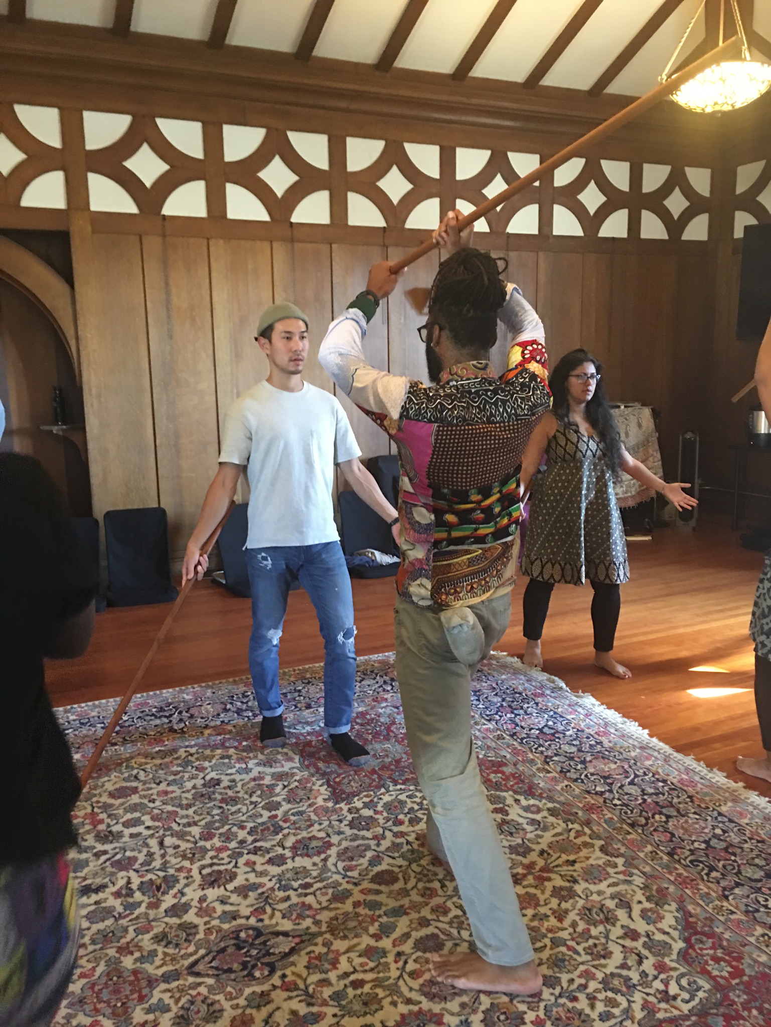 Photo of three generative somatics students in jo practice. Used with permission of gs.