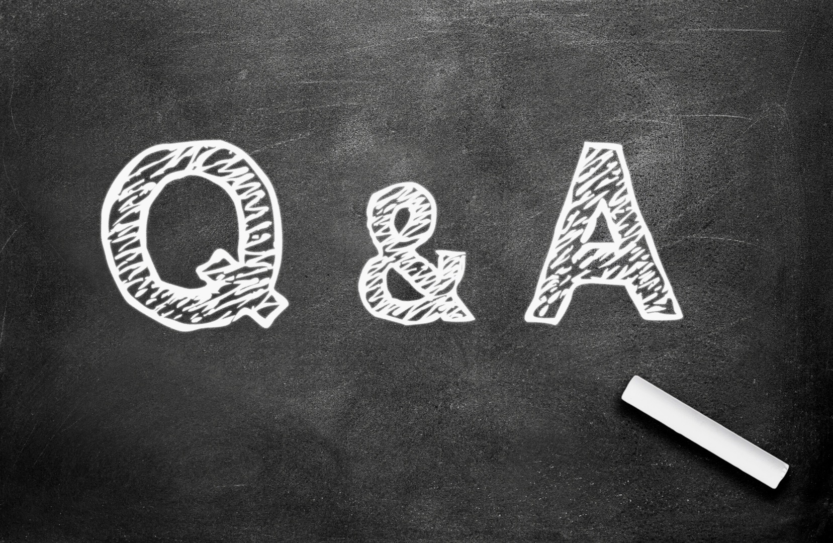 This image shows Q&A written in white chalk on a black chalkboard.
