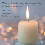 This image reads “What is currently giving me energy—firing me up or inspiring me? and other questions for the new year …” against a light blue-gray background. A cream-colored candle and flame appear with pink-peach glowing dots. Attribution to Heart-Head-Hands.com appears in the lower right-hand corner.