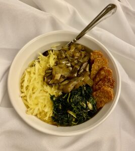 Bowl of sautéed greens, spaghetti squash, mushroom gravy, and these tempeh sticks.