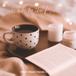 Image says “Subscribe for the New Year” with a light pink background of a blanket, tray with tea, candles, and open book.