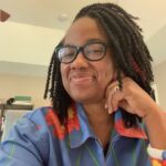 Photo shows a close-up of Candace Epps-Robertson, Ph.D. with head tilted to the side and smiling.