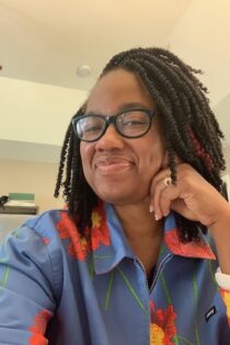 Photo shows a close-up of Candace Epps-Robertson, Ph.D. with head tilted to the side and smiling.